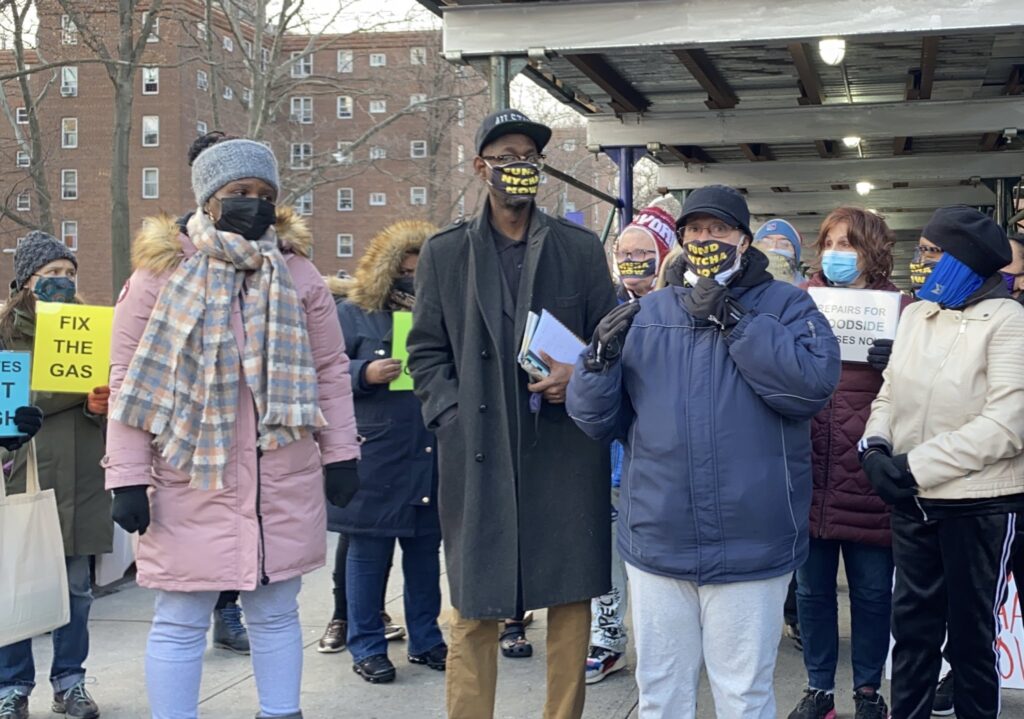 Tenants and organizers speak at a press conference outside Woodside Houses, adorned in SAVE NYCHA NOW masks.